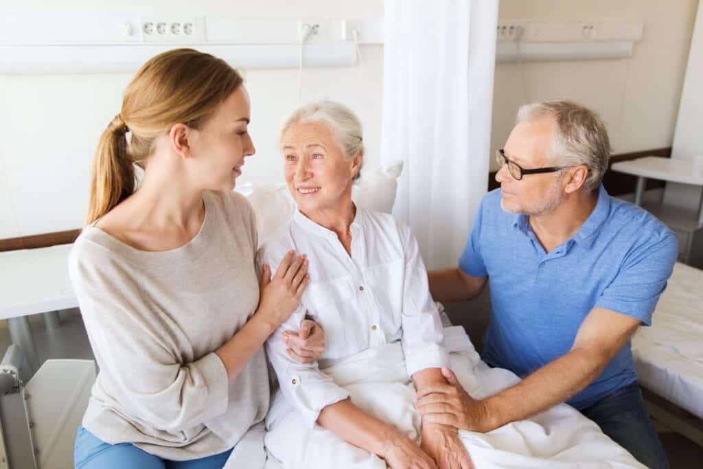 An elderly womain with dementia talking to her family in Lavender Springs